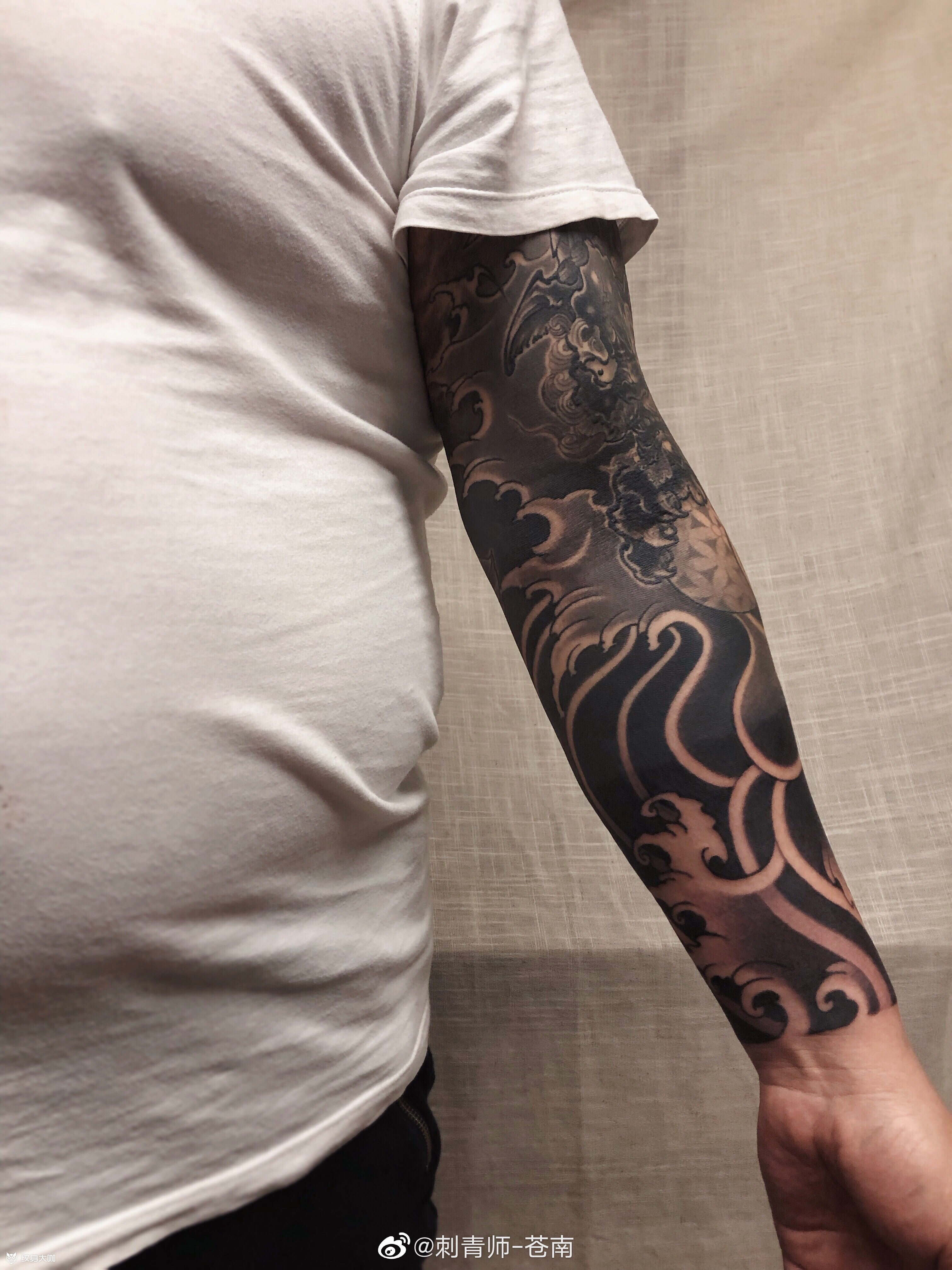 花臂青岛的老顾客3年前做的唐狮七分袖今日来接满切记传统类型的纹身